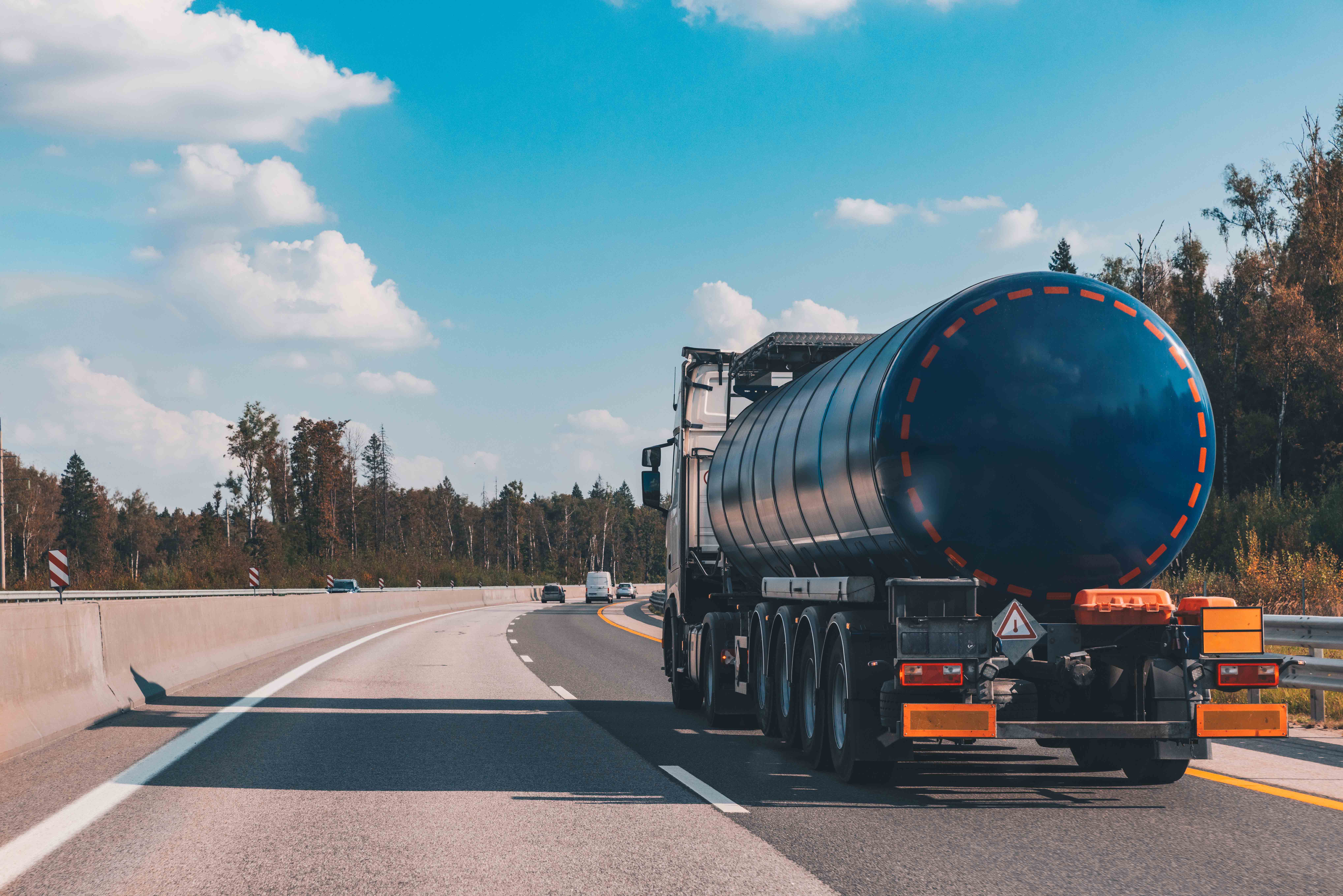 Fuel tanker truck on the highway asphalt road on fall autumn day